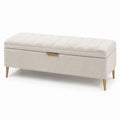 Panca contenitore in tessuto beige con gambe in metallo dorato